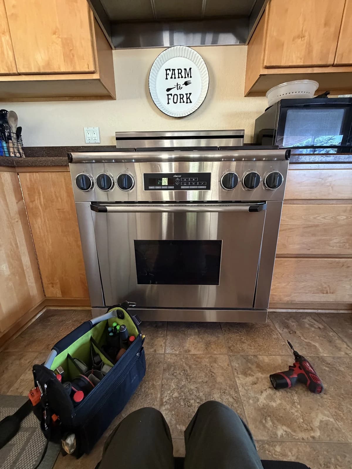 OPUS technician repairing a heating element on a Dacor double wall oven in San Diego