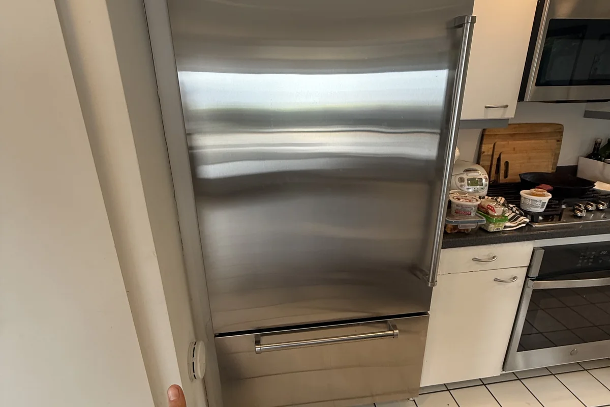 OPUS technician giving a thumbs up after completing a Sub-Zero refrigerator repair in San Diego