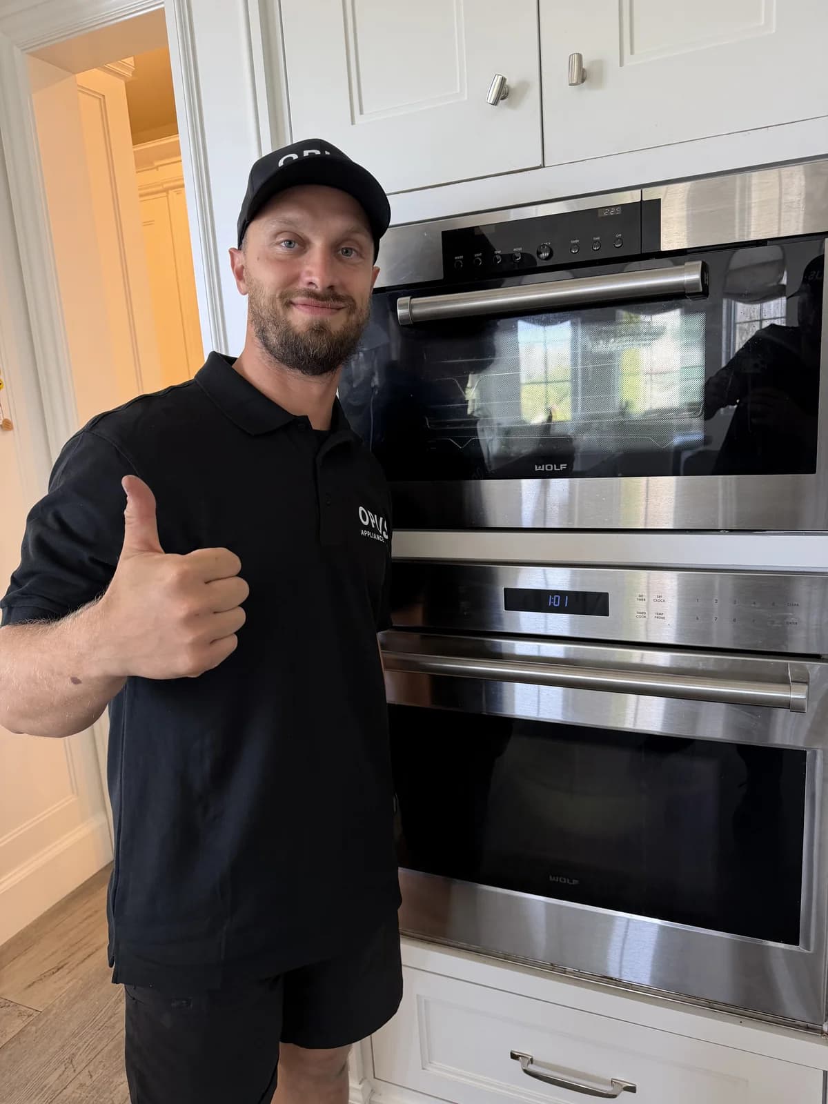 OPUS technician next to a Wolf double wall oven in Rancho Santa Fe, San Diego