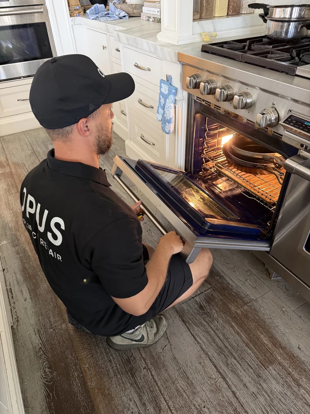 Wolf range with door open during burner service — OPUS service in Rancho Santa Fe