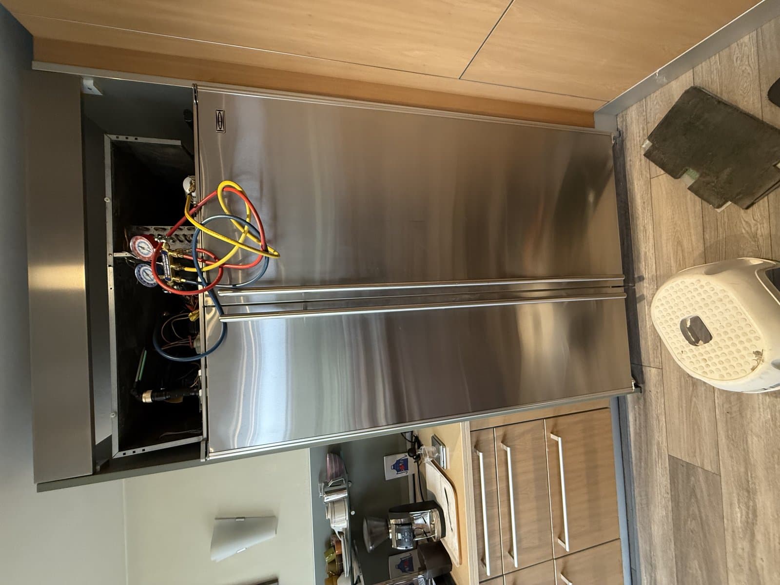 OPUS technician servicing a Fisher & Paykel refrigerator in San Diego